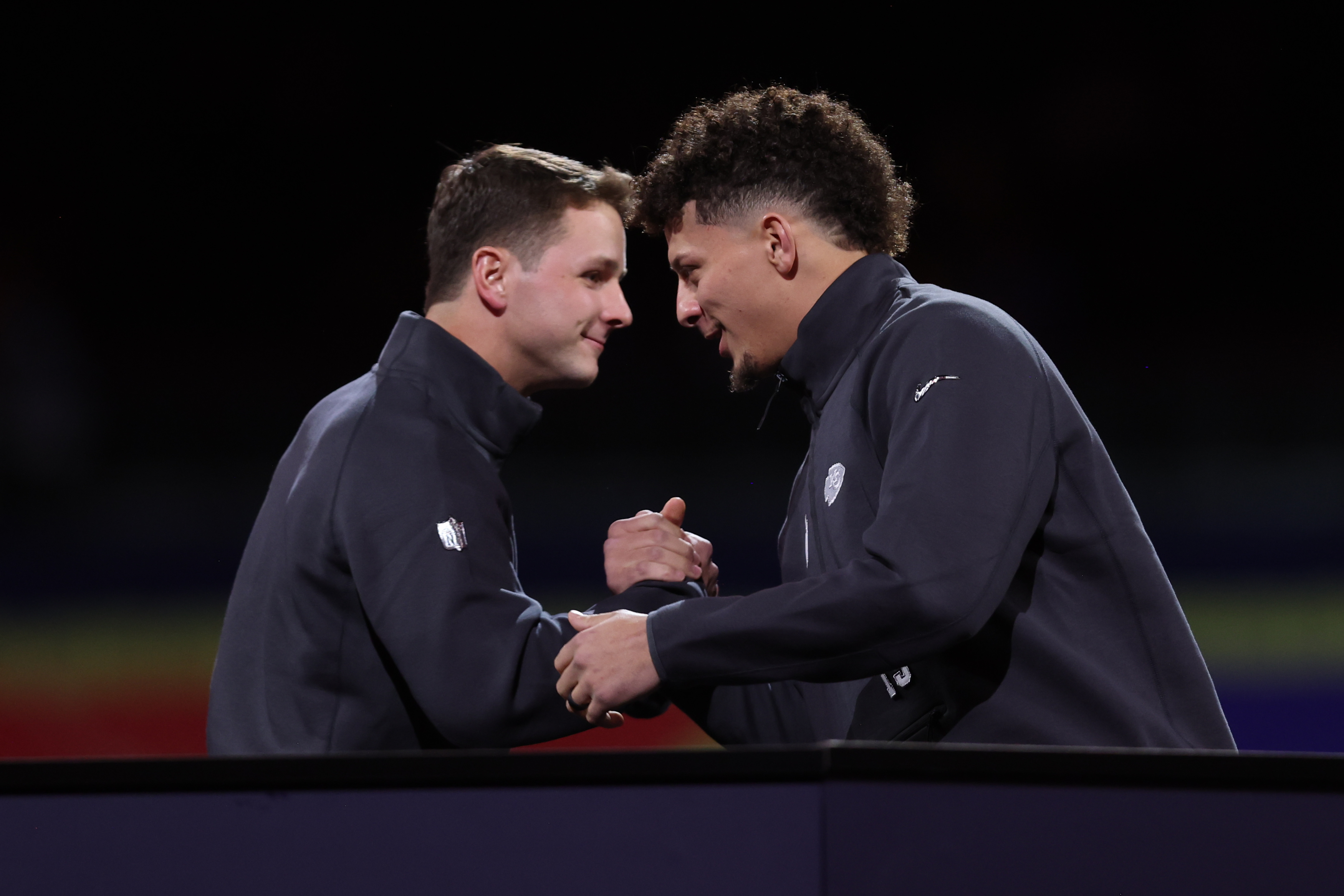 Brock Purdy #13 of the San Francisco 49ers and Patrick Mahomes #15 of the Kansas City Chiefs shake hands during Super Bowl LVIII Opening Night at Allegiant Stadium on February 5, 2024 in Las Vegas, NV.